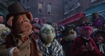 Movie still from “The Muppet Christmas Carol” (1992), directed by Brian Henson – A group of people wearing masks in a crowd; Medium shot, Low angle