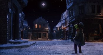 Movie still from “The Muppet Christmas Carol” (1992), directed by Brian Henson – A street scene with a person standing in the middle of the street; Extreme Wide shot, High angle