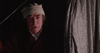 Movie still from “The Muppet Christmas Carol” (1992), directed by Brian Henson – A man wearing a white hat and a brown jacket; Close Up shot, Low angle