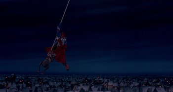 Movie still from “The Muppet Christmas Carol” (1992), directed by Brian Henson – An image of a person hanging from a rope in the night sky; Extreme Wide shot, Low angle