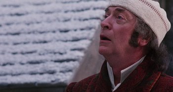 Movie still from “The Muppet Christmas Carol” (1992), directed by Brian Henson – An older man wearing a white hat looking up; Close Up shot, Low angle