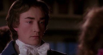 Movie still from “The Muppet Christmas Carol” (1992), directed by Brian Henson – A man in a suit and bow tie looking to his left; Close Up shot, Over the shoulder angle