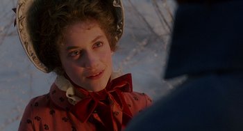 Movie still from “The Muppet Christmas Carol” (1992), directed by Brian Henson – A young girl wearing a red dress and a red hat; Close Up shot, Over the shoulder angle