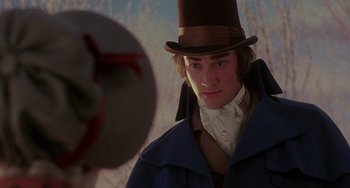 Movie still from “The Muppet Christmas Carol” (1992), directed by Brian Henson – A young man in a top hat and a coat; Close Up shot, Over the shoulder angle