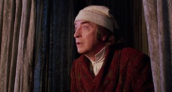 Movie still from “The Muppet Christmas Carol” (1992), directed by Brian Henson – An older man wearing a white hat looking off into the distance; Close Up shot, Low angle