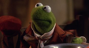 Movie still from “The Muppet Christmas Carol” (1992), directed by Brian Henson – A stuffed animal wearing a suit; Close Up shot, Over the shoulder angle