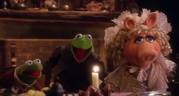 Movie still from “The Muppet Christmas Carol” (1992), directed by Brian Henson – A stuffed animal sitting next to another stuffed animal; Medium shot, High angle