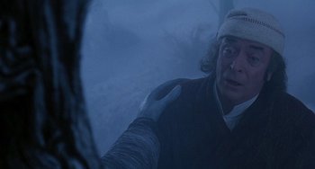 Movie still from “The Muppet Christmas Carol” (1992), directed by Brian Henson – A man with a bandaged head is looking into a mirror; Close Up shot, Over the shoulder angle