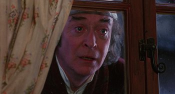 Movie still from “The Muppet Christmas Carol” (1992), directed by Brian Henson – An older man looking in a mirror with a surprised look on his face; Close Up shot, Over the shoulder angle