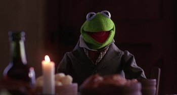 Movie still from “The Muppet Christmas Carol” (1992), directed by Brian Henson – The head of a muppet character; Medium shot, Over the shoulder angle
