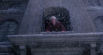 Movie still from “The Muppet Christmas Carol” (1992), directed by Brian Henson – An old man standing on a ledge in the snow; Wide shot, Low angle