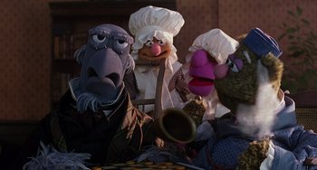 Movie still from “The Muppet Christmas Carol” (1992), directed by Brian Henson – A group of people dressed up as muppets; Medium shot, High angle