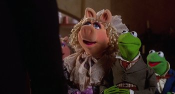 Movie still from “The Muppet Christmas Carol” (1992), directed by Brian Henson – A group of people that are standing next to each other; Medium shot, High angle