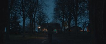 Movie still from “Riders of Justice” (2020), directed by Anders Thomas Jensen – A person standing in the middle of a road at night; Extreme Wide shot, Low angle