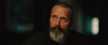 Movie still from “Riders of Justice” (2020), directed by Anders Thomas Jensen – A man with a long beard and a goatee looking to his left; Close Up shot, Low angle