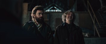 Movie still from “Riders of Justice” (2020), directed by Anders Thomas Jensen – A couple of men standing next to each other; Medium shot, Low angle