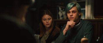 Movie still from “Riders of Justice” (2020), directed by Anders Thomas Jensen – A man and a woman sitting next to each other in a room; Close Up shot, Over the shoulder angle