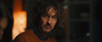 Movie still from “Riders of Justice” (2020), directed by Anders Thomas Jensen – A person wearing a sweater; Close Up shot, Over the shoulder angle