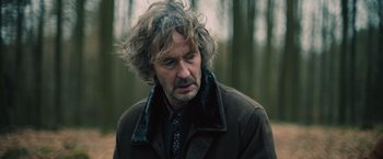 Movie still from “Riders of Justice” (2020), directed by Anders Thomas Jensen – A person wearing a jacket; Close Up shot, Over the shoulder angle