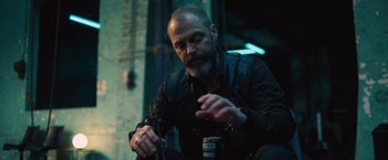 Movie still from “Riders of Justice” (2020), directed by Anders Thomas Jensen – A man with a beard is holding a can of beer; Medium shot, Low angle