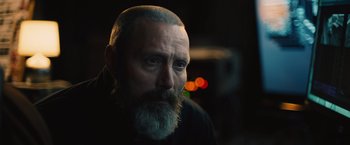 Movie still from “Riders of Justice” (2020), directed by Anders Thomas Jensen – A man with a gray beard is looking at the camera; Close Up shot, Over the shoulder angle