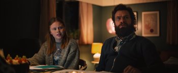 Movie still from “Riders of Justice” (2020), directed by Anders Thomas Jensen – A man and a woman sitting at a dinner table; Medium shot, Over the shoulder angle