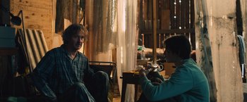 Movie still from “Riders of Justice” (2020), directed by Anders Thomas Jensen – A man and a woman are sitting in a room; Medium shot, Over the shoulder angle