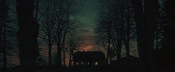 Movie still from “Riders of Justice” (2020), directed by Anders Thomas Jensen – A house in the middle of the night with trees in the background; Extreme Wide shot, Low angle