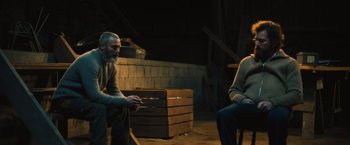 Movie still from “Riders of Justice” (2020), directed by Anders Thomas Jensen – Two people sitting in a room talking to each other; Medium shot, Over the shoulder angle