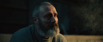 Movie still from “Riders of Justice” (2020), directed by Anders Thomas Jensen – An old man with a beard and a gray sweater; Close Up shot, Low angle