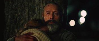 Movie still from “Riders of Justice” (2020), directed by Anders Thomas Jensen – A man with a beard is holding a child; Close Up shot, Overhead angle