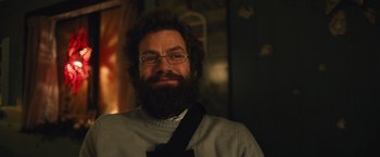 Movie still from “Riders of Justice” (2020), directed by Anders Thomas Jensen – A man with a beard wearing glasses and a sweater; Close Up shot, Over the shoulder angle