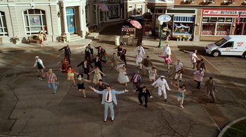 Movie still from “The Muppets” (2011), directed by James Bobin – A group of people standing on the street; Extreme Wide shot, High angle