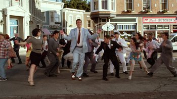 Movie still from “The Muppets” (2011), directed by James Bobin – A group of men in suits and ties dancing on the street; Wide shot, High angle