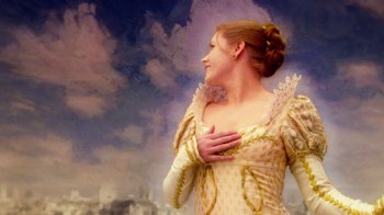Movie still from “The Muppets” (2011), directed by James Bobin – A beautiful woman in a yellow dress holding her hands to her chest; Close Up shot, Low angle