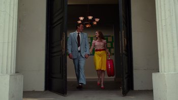 Movie still from “The Muppets” (2011), directed by James Bobin – A man and a woman are walking through a doorway; Wide shot, Low angle