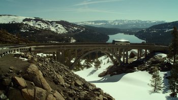 Movie still from “The Muppets” (2011), directed by James Bobin – A truck driving over a bridge over a river; Extreme Wide shot, Low angle