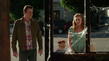 Movie still from “The Muppets” (2011), directed by James Bobin – A man and a woman standing in front of a puppet; Medium shot, Over the shoulder angle