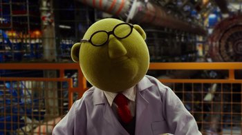 Movie still from “The Muppets” (2011), directed by James Bobin – A stuffed animal wearing a lab coat and tie; Medium shot, Low angle