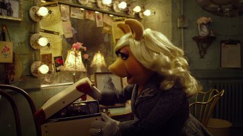 Movie still from “The Muppets” (2011), directed by James Bobin – A woman dressed as miss piggy in front of a mirror; Medium shot, High angle