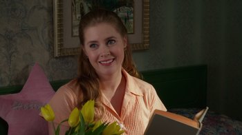 Movie still from “The Muppets” (2011), directed by James Bobin – A woman sitting at a table with a bouquet of yellow flowers; Close Up shot, Over the shoulder angle