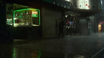 Movie still from “The Muppets” (2011), directed by James Bobin – A man walking down a street in the rain; Extreme Wide shot, High angle