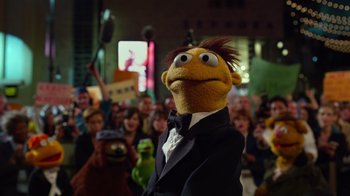 Movie still from “The Muppets” (2011), directed by James Bobin – A crowd of people watching a person dressed as a muppet; Medium shot, Low angle