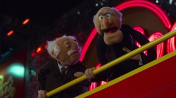 Movie still from “The Muppets” (2011), directed by James Bobin – A couple of people that are standing next to each other; Medium shot, Low angle