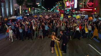 Movie still from “The Muppets” (2011), directed by James Bobin – A crowd of people walking down a street at night; Extreme Wide shot, High angle