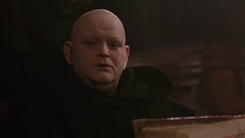 Movie still from “The Name of the Rose” (1986), directed by Jean-Jacques Annaud – A bald man in a black monk's outfit; Close Up shot, Low angle