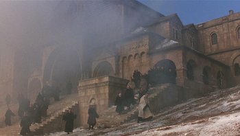 Movie still from “The Name of the Rose” (1986), directed by Jean-Jacques Annaud – A group of people walking up a set of stairs; Extreme Wide shot, High angle