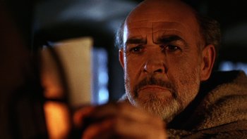 Movie still from “The Name of the Rose” (1986), directed by Jean-Jacques Annaud – An older man looking at a cell phone; Close Up shot, Low angle