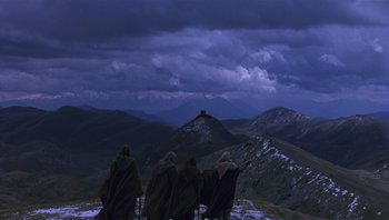 Movie still from “The Name of the Rose” (1986), directed by Jean-Jacques Annaud – A group of people standing on top of a mountain; Extreme Wide shot, Low angle