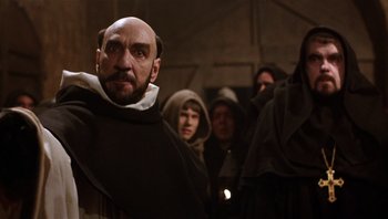 Movie still from “The Name of the Rose” (1986), directed by Jean-Jacques Annaud – A group of people dressed as monks in a room; Medium shot, Low angle